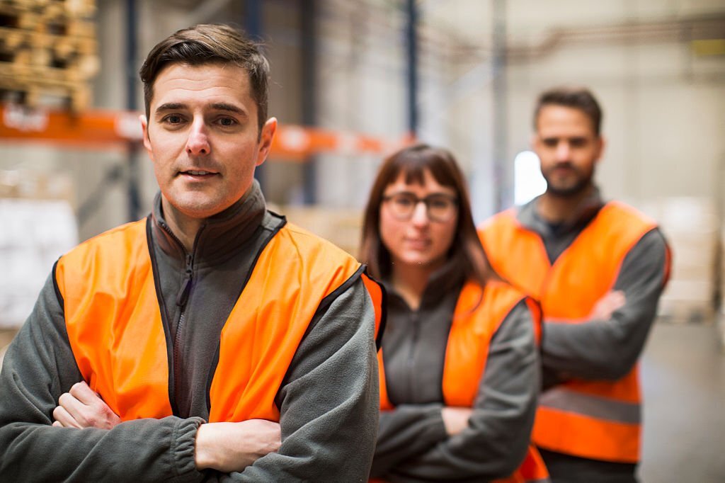 Warehouse workers portrait in work overalls